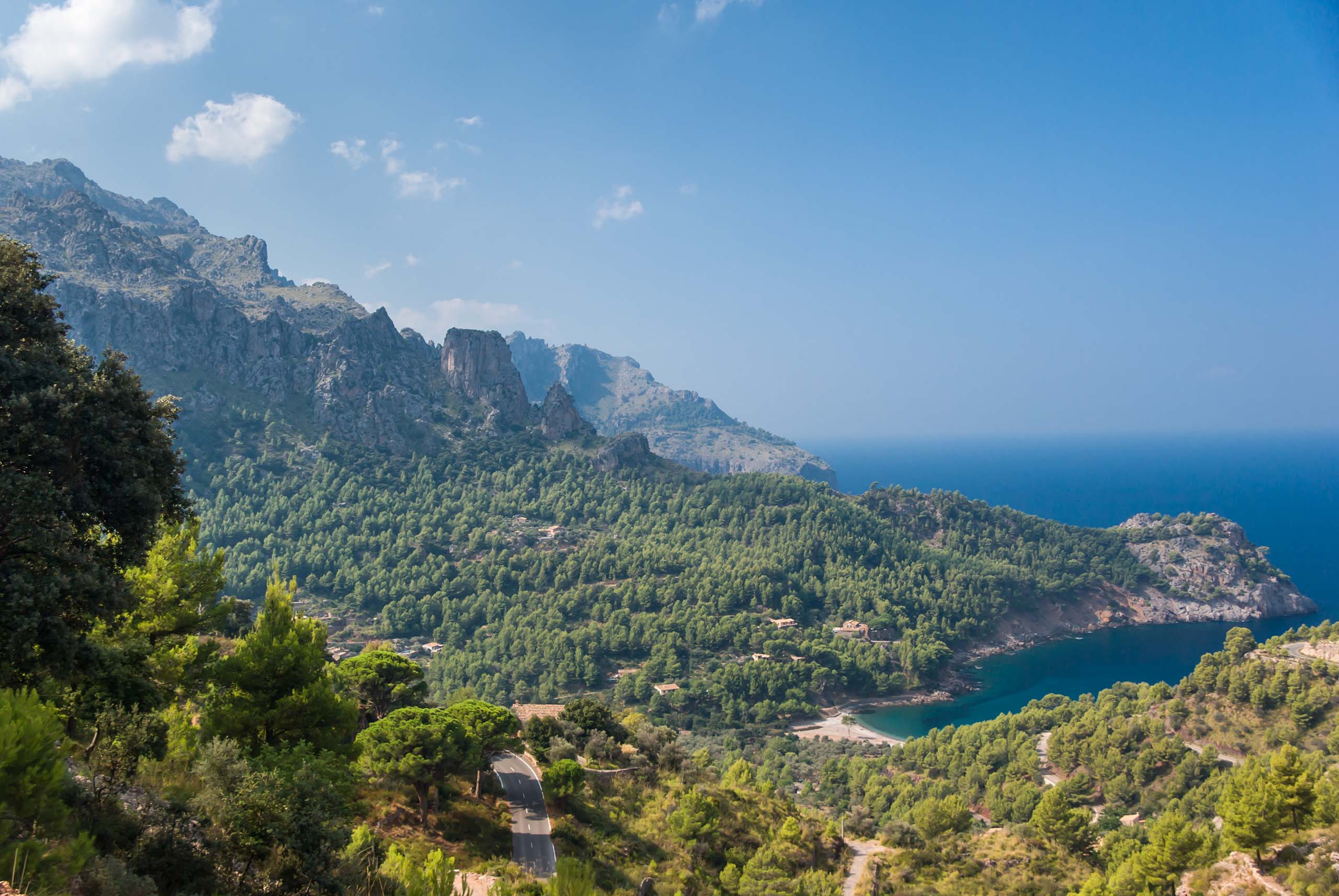 Panoramic view of Cala Tuent and the Mediterranean Sea on a sunny day.