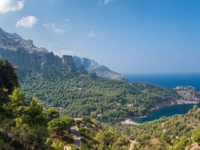 Panoramic view of Cala Tuent and the Mediterranean Sea on a sunny day.